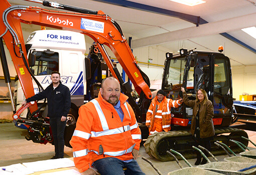 Masonry Solutions Ltd employees with plant hire orange excavator and truck.
