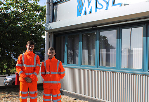 Two Business Modern Apprentices outside the Masonry Solutions Ltd office.