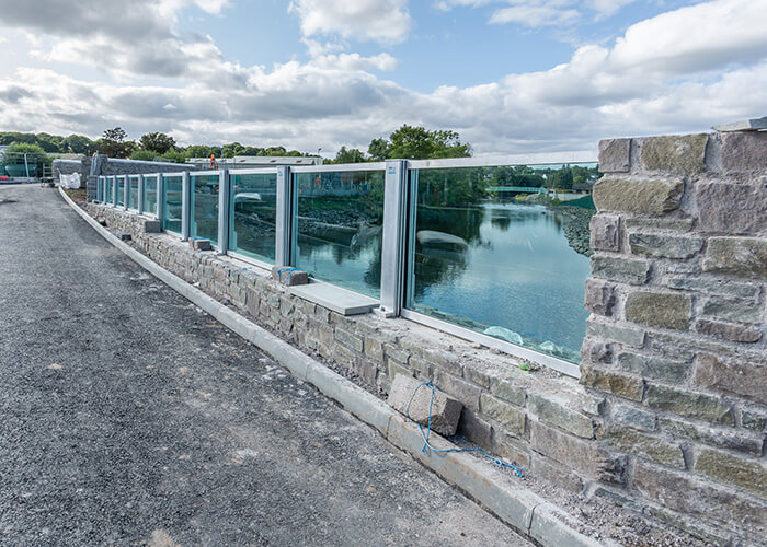 Exterior glass panel and stone wall at the Water of Leith Flood Prevention project Almondvale.