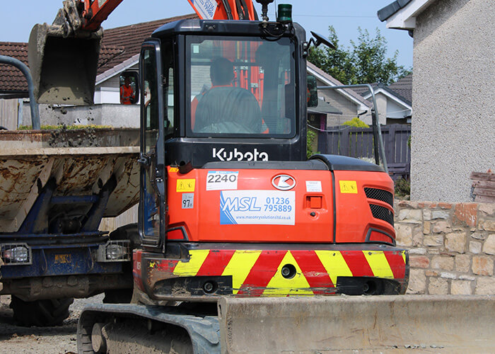 Masonry Solutions Ltd orange excavator for hire.
